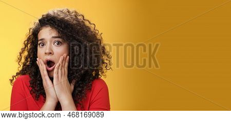 Indoor Shot Of Shocked Female Drama Queen With Curly Hair Gasping In Surprise, Feeling Empathy And F