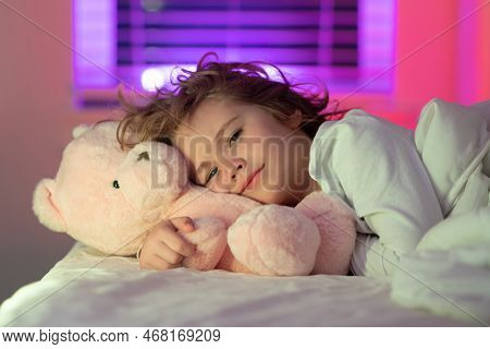 Kid In Bed With Toy Teddy Bear. Nap And Sleep Time. Favorite Toy For Sleep. Bedding And Sleepwear Fo