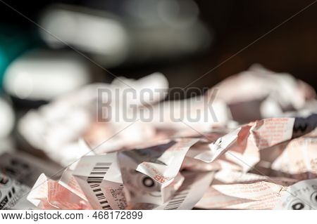 Sioux Falls, South Dakota, Usa - 11.2022 - Pile Of Wadded Up And Crumpled Losing Powerball Lottery T