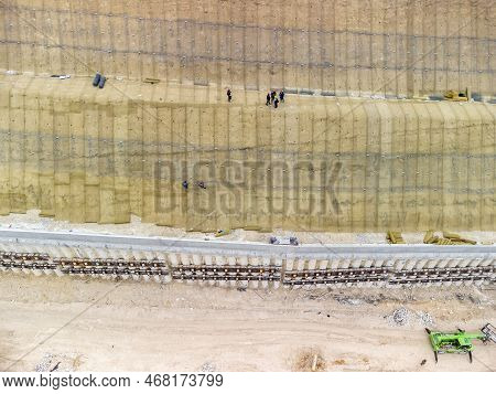 Mountain Road Constraction. Workers Reinforce The Slope Over The New Road. Road Construction In Prog