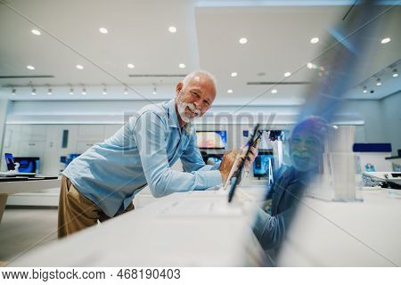 Seniors Shopping Appliences And Gadgets In Tech Store.