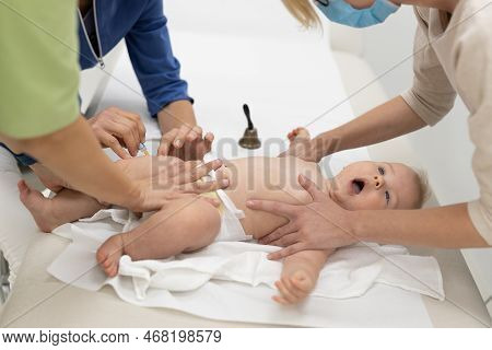 Baby Beeing Vaccinated By Pediatrician In Presence Of His Mother. Preventive Vaccination Against Dip