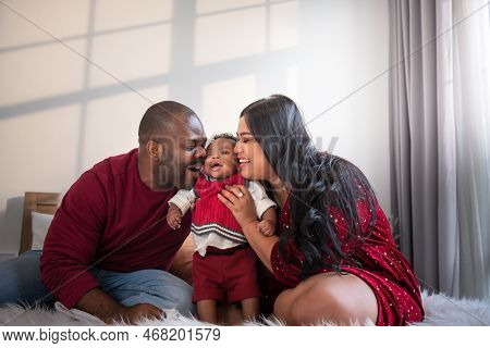 African Family, Nigerian Father, Asian Mother Holding And Kissing A 4-month-old Baby Newborn Son, Th