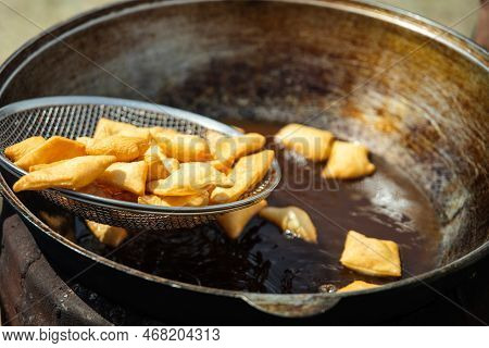 Baursaks Are Roasted In A Large Cauldron Outdoor
