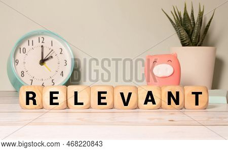 Relevant Word Written In Wooden Cube. Concept
