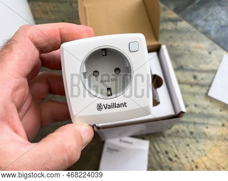 London, United Kingdom - Jan 1, 2022: Close-up Male Hand Holding New Socket Plug Vaillant Ambisense 