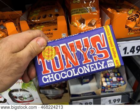 Dortmund, Germany - Feb 19, 2022: Pov Male Hand Holding Package Pack With Tonys Chocolonely Toffee C