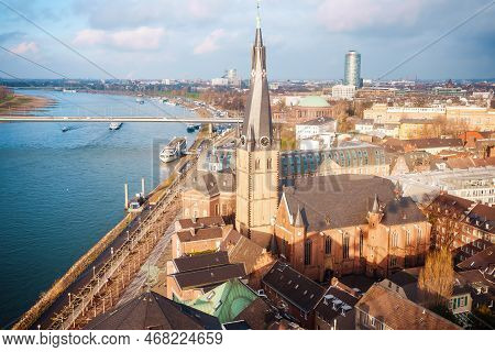 Skyline Of Dusseldorf With Church View Near Canal.
