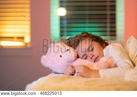 Sweet Sleep. Kid Sleeping With A Toy Teddy Bear In Bed. Child Sleeping In Bed Under Blanket. Kid Lyi