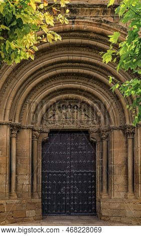 Romanesque Portal Decorated With Carvings Of The Saints On The Archivolt Of Iglesia De San Pedro, Or