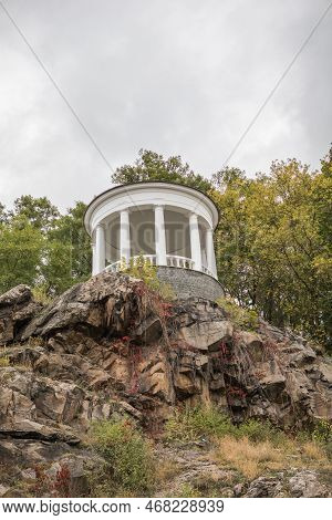 White Gazebo In City Park Of Zhytomyr, Ukraine At Sunny Autumn Day. Picturesque View On Colourful Hi