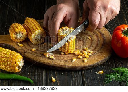 Chef Cuts Corn Kernels With A Knife. Maize Is An Excellent Dietary Breakfast Or Lunch By The Cook Ha