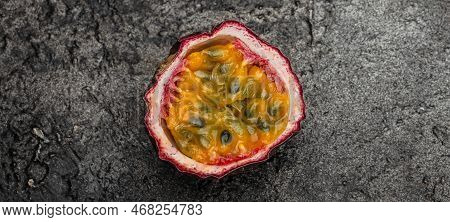 Passion Fruit Maracuya Cut In Half Slice On A Dark Background, Long Banner Format. Top View,