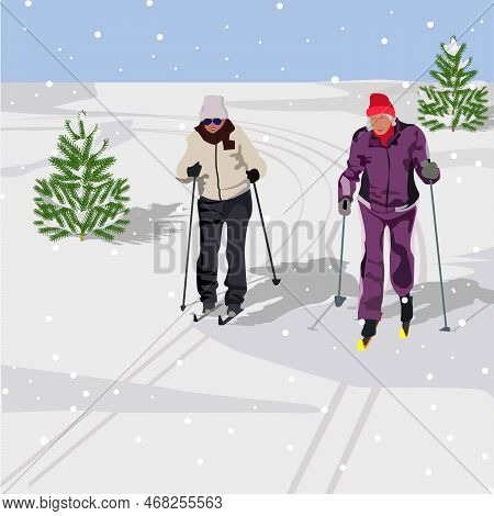 Active Elderly Women On Skis Move Along The Ski Track At Training In The Winter Forest During A Snow