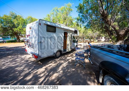 Motorhome With Family Parked In Matala Camping, Crete, Greece. Family Is Camping In Campgrounds With