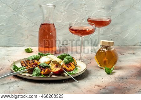 Gourmet Roasted Peaches With Burrata Soft Cheese, Basil And Drizzled With Honey, With Rose Wine. Ant