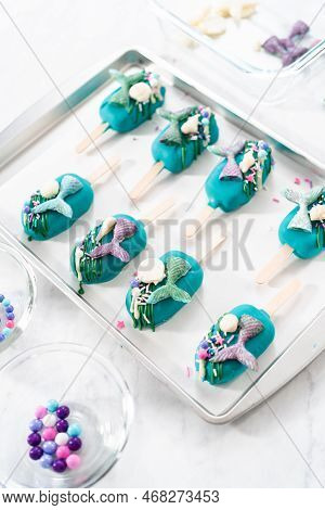Decorating Cakesicles With Drizzled Chocolate, Chocolate Mermaid Tails, And Seashells.