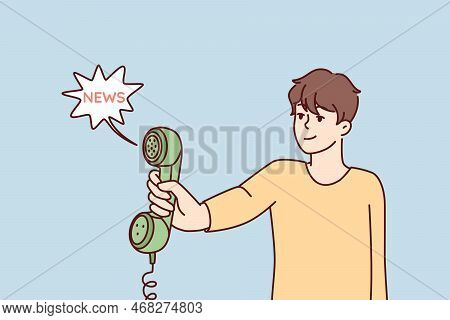 Man Holds Out Landline Phone To Share News Or Important Information. Handset With Wire In Hand Of Yo