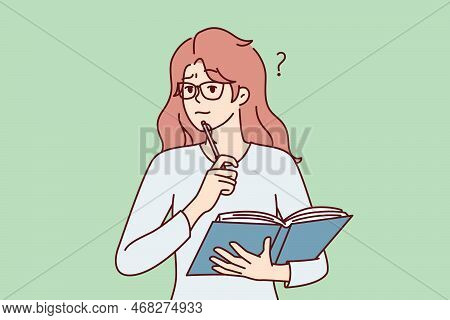 Thoughtful Woman With Open Textbook Puts Pen To Chin Remembering Correct Answer To Questions. Perple