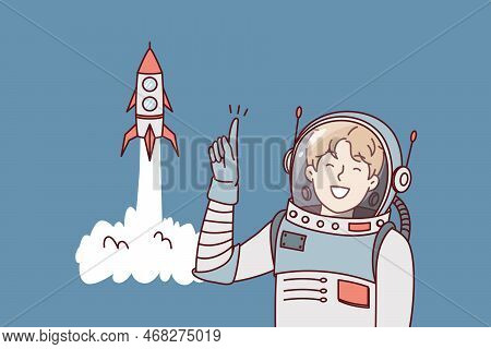 Man In Astronaut Clothes Points Finger Up Standing Near Spaceship Taking Off. Guy In Spacesuit Is Me