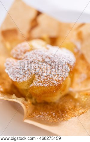 Eating Freshly Baked Apple Sharlotka Muffin Dusted With Powdered Sugar.