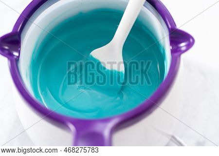 Melting Chocolate Melts In A Candy Melting Pot To Prepare Mermaid Cakesicles.