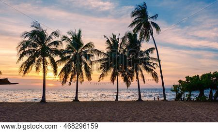 White Tropical Beach During Sunset In Pattaya Najomtien. Palm Trees At The Beach During Sunset
