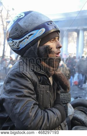 Kyiv, Ukraine - January 24 2014: Man Wearing A Motorcycle Helmet Sings Anthem During Dignity Revolut