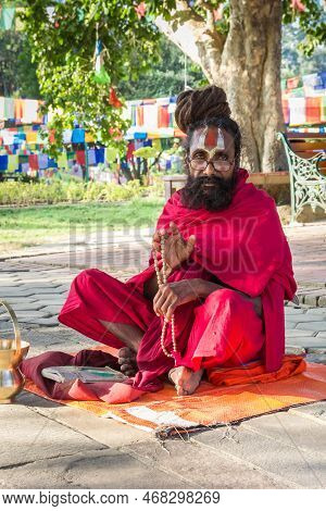Lumbini, Nepal - November 09, 2019: Traditional Monk Giving His Blessing At The Mayadevi Temple In L