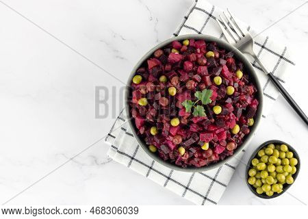 Russian Salad - Vinegret Of Boiled Beets, Potatoes, Carrots, Green Peas On A White Background. Copy 