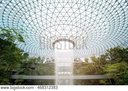 Changi, Singapore - 26/12/2022 : Jewel Changi Airport , Artificial Waterfall Dome With Plants Where