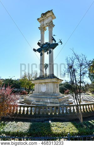 Beautiful Garden In Springtime Landscape In Seville, Andalusia, Spain. Christopher Columbus Monument