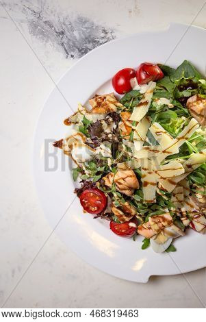 Top View Salad With Shrimp And Tomatoes, Cheese And Herbs On A Plate In A Restaurant.