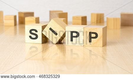 Four Wooden Blocks With Text Sipp On Table. Copy Space. White Background.