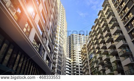 The Narrow Passage Between Modern Residential Buildings. Walls Of High-rise Apartment Buildings And 