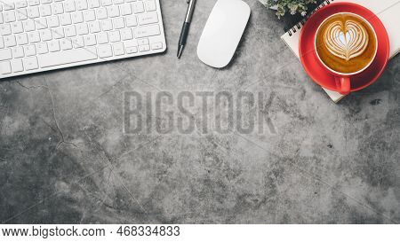 Dark Office Desk Workspace With Keyboard Computer, Pen, Mouse, Notebook And Cup Of Coffee, Top View 