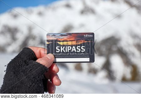Alpe Dhuez, France - Circa 2022: Ski Pass Held In Hand By Skier In A Snowy Mountain Landscape Oz Vau