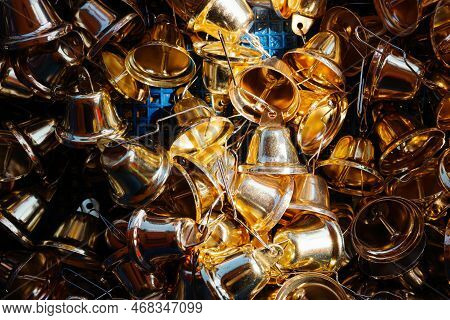 Close Focus On Group Of Small Golden Bells Prepared For Worshiper Who Come To The Temple.