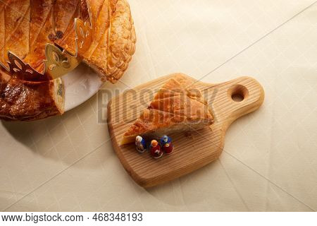 King Cake Or Galette Des Rois In French. Epiphany Pie With Golden Paper Crown And Little Ceramic Fig