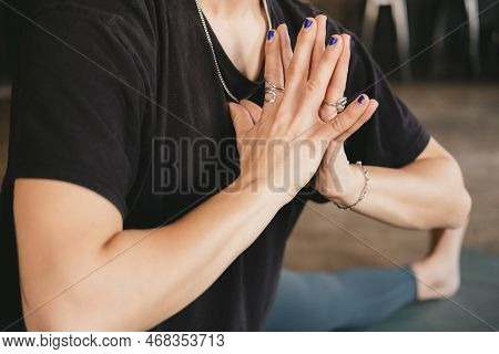 Side Close-up Photo Of The Torso And Hands Of A Woman Yogi And New Teacher Doing A Skandasana Pose W