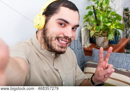 Man With Headphone Taking Selfie Pic At Home.