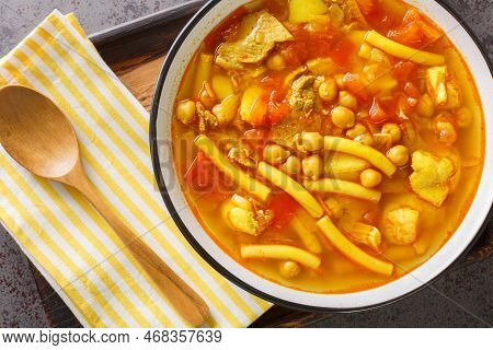 Canarian Soup With Meat, Pasta, Chickpeas And Vegetables Close-up On A Plate On The Table. Horizonta