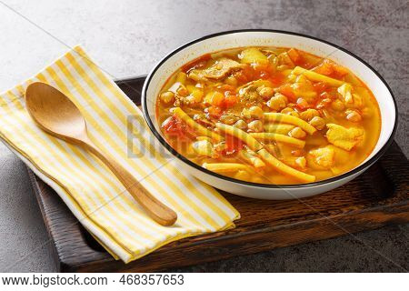 Canarian Soup With Meat, Pasta, Chickpeas And Vegetables Close-up On A Plate On The Table. Horizonta