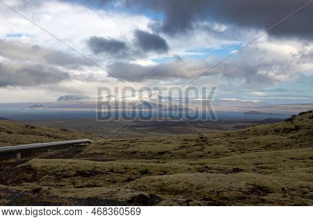 Country Covered By Lichen And Grass. Dark Blue Water Of The Lake Thingvallavatn. Mountains Covered B