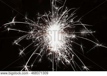 Christmas Background. A Sparkler On A Christmas Tree In The Evening Outside With Snow. Concept For W