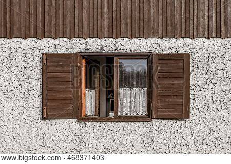 Wooden Shutters On An Old Cottage, Very Rough Stucco Wall