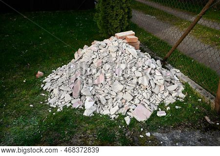 A Pile Of Bricks, Stones And Rubble From Construction Intended For Disposal, A Black Dump