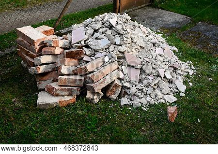 A Pile Of Bricks, Stones And Rubble From Construction Intended For Disposal, A Black Dump