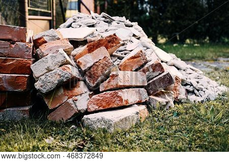 A Pile Of Bricks, Stones And Rubble From Construction Intended For Disposal, A Black Dump