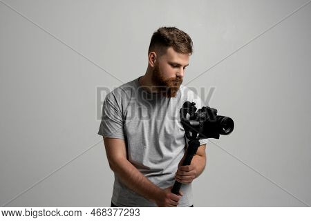 Side View Of Professional Bearded Videographer, Cinematographer, Cameraman Using Camera On Gimbal St